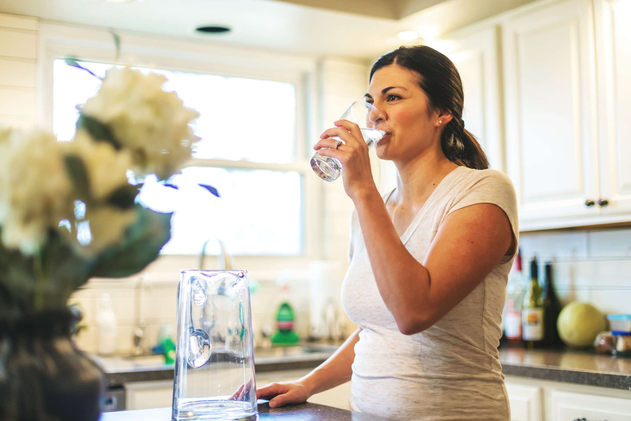 Woman drinking clean water in residential home